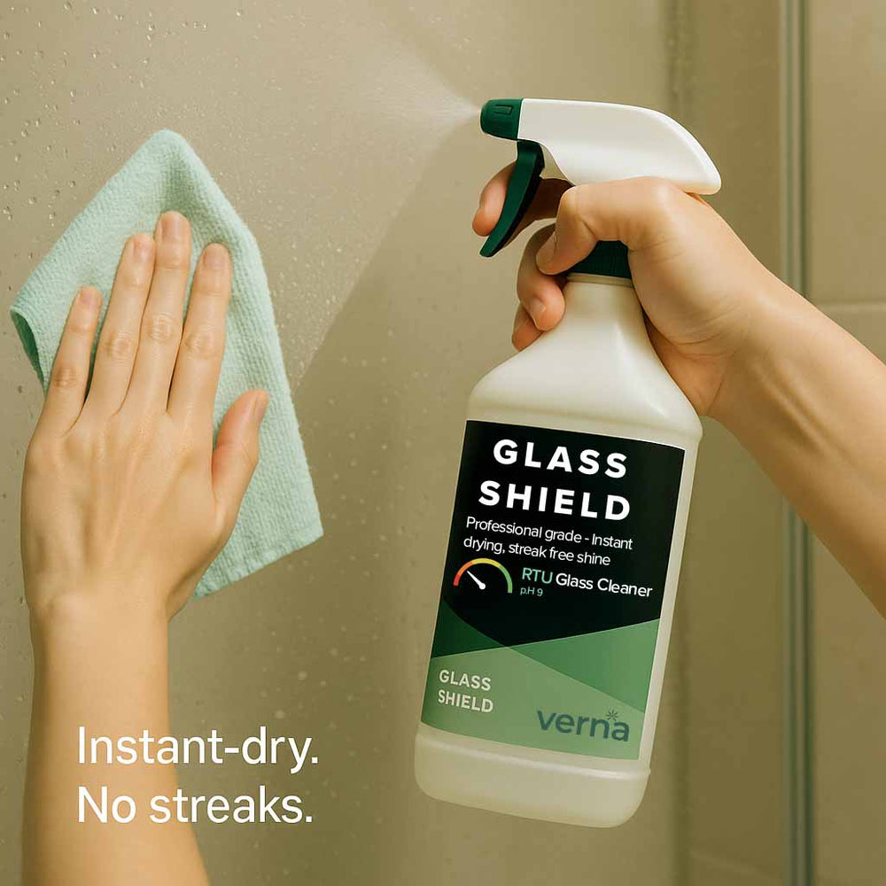Spraying glass shield onto glass cleaning streak free with glass cleaner by Verna.